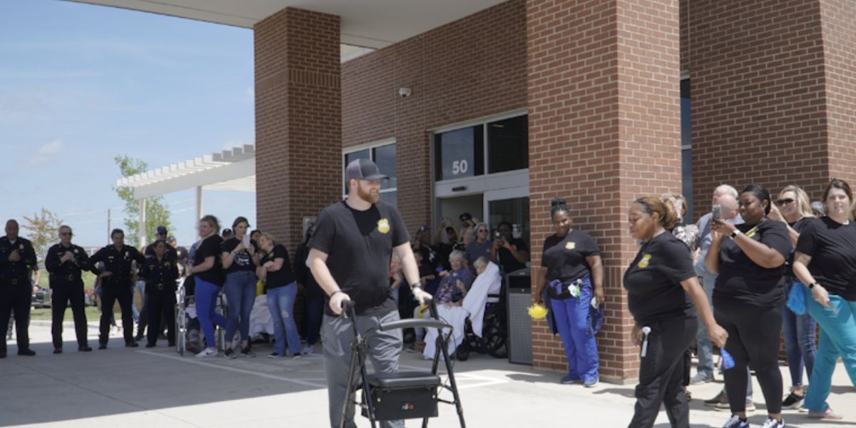 Dallas Officer Shot Shows Progress, Takes First Steps Amidst Supportive Cheers