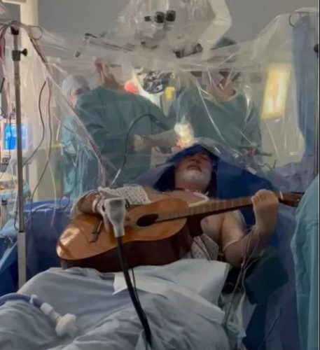 Watch the moment man plays guitar while having brain surgery to remove ‘golf ball-sized’ tumour