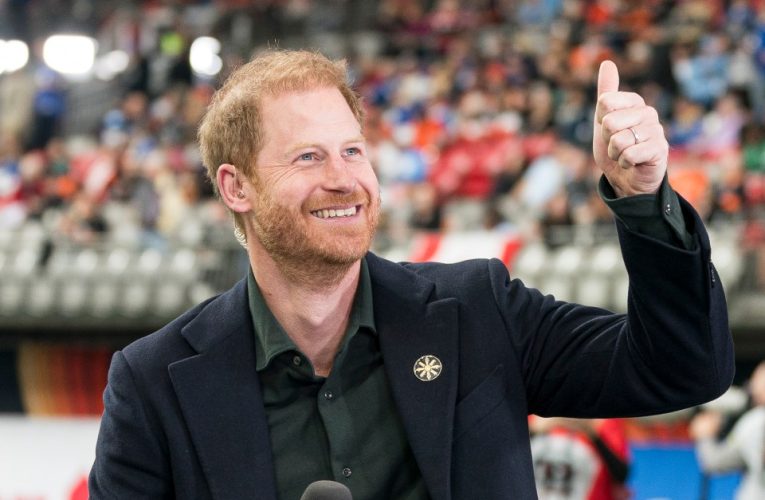 Smiling Prince Harry gives thumbs up to Canadian football fans in ANOTHER public appearance without Meghan