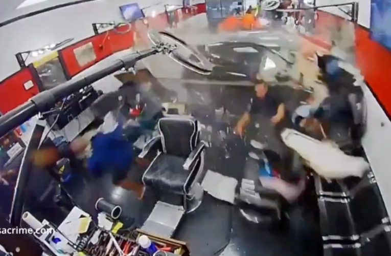 Horror moment Porsche crashes through busy barber shop sending customers running and leaving boy, 10, injured