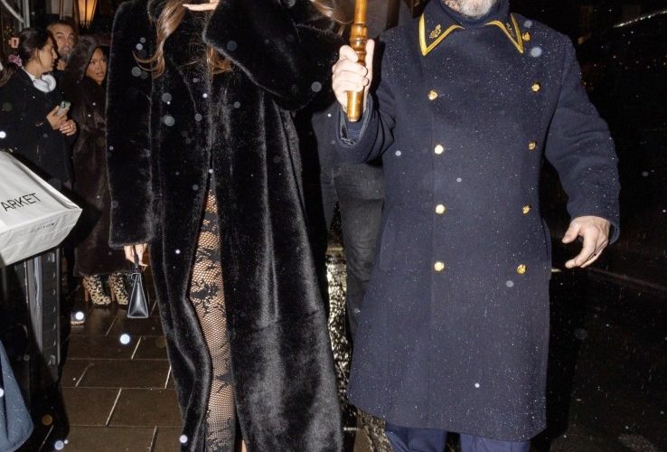 Khloe Kardashian goes pantless in sheer tights and long fur coat as she steps out of swanky London hotel in the rain