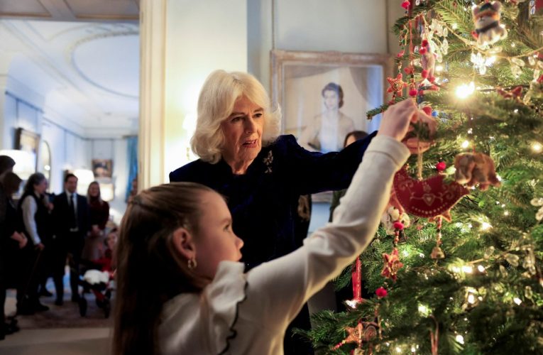 Queen Camilla decorates Christmas tree with terminally ill youngsters as she treats them to morning of festive fun