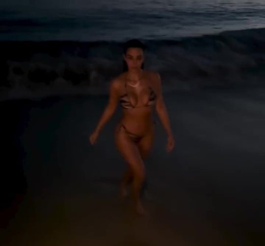 Kim Kardashian looks incredible as she strips off to tiger print bikini and goes for a dip in the ocean